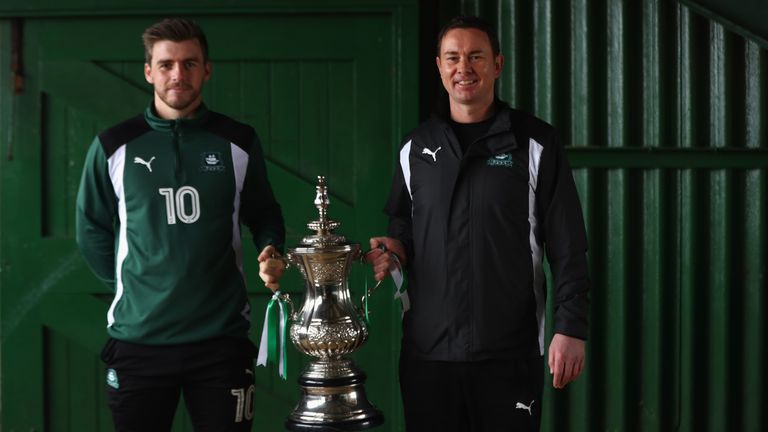 Derek Adams (R) the manager of Plymouth Argyle and player Graham Carey hold a replica FA Cup during the Plymouth Argyle Media Access Day