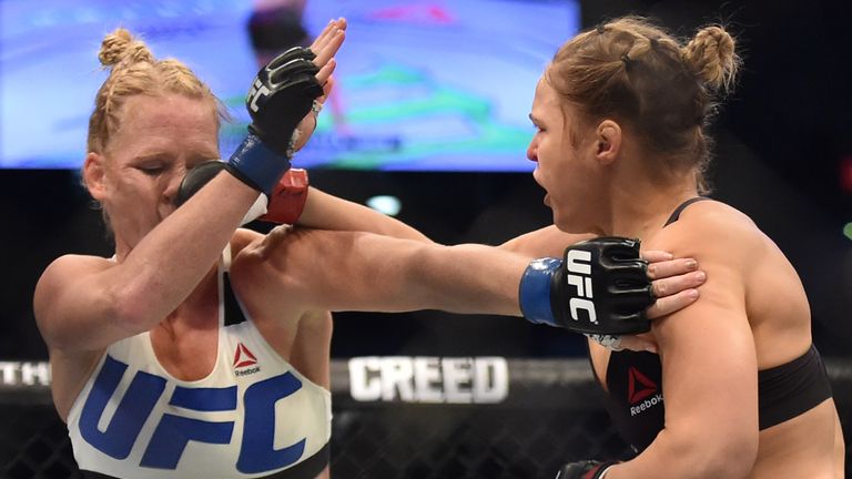 Ronda Rousey of the US (R) lands a punch on the face of compatriot Holly Holm during the UFC title fight in Melbourne on November 15, 2015.   RESTRICTED TO