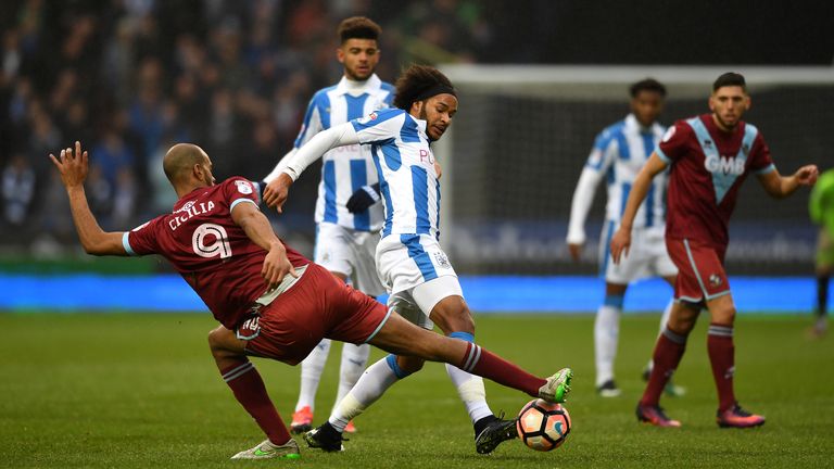 HUDDERSFIELD, ENGLAND - JANUARY 07 2017:  Isaiah Brown of Huddersfield is tackled by Rigino Cicilia of Port Vale during an FA Cup Third Round match