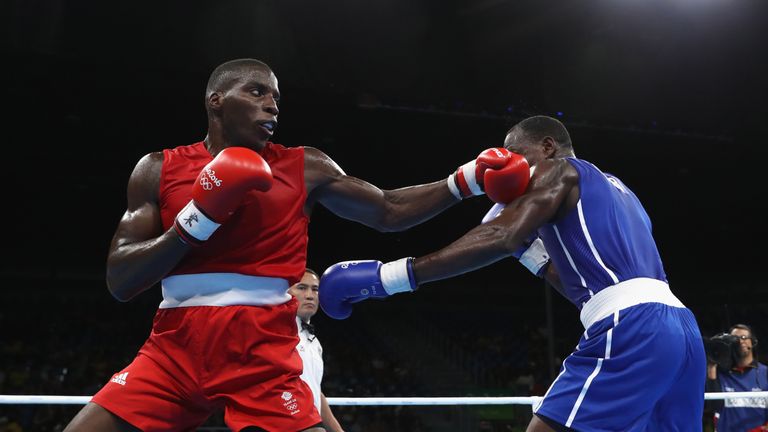 RIO DE JANEIRO, BRAZIL - AUGUST 08:  Lawrence Okolie of Great Britain (red) fights Erislandy Savon of Cuba (blue) in their Mens 91kg Heavyweight bout on Da
