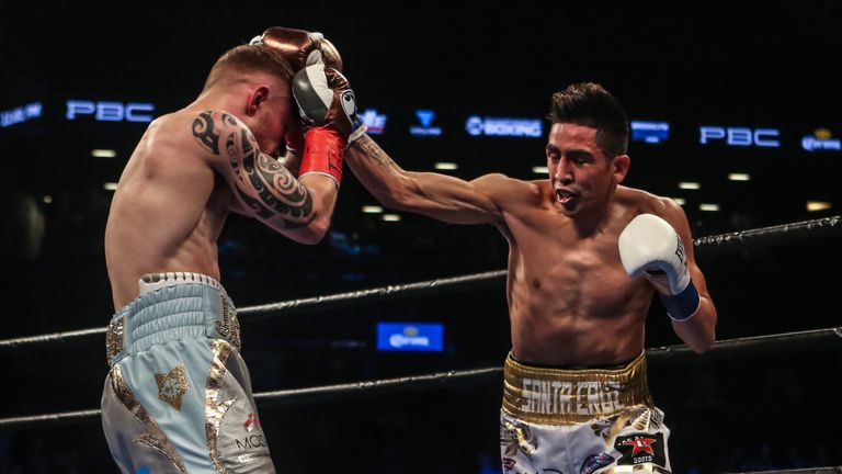 NEW YORK, NY - JULY 30: Leo Santa Cruz of Mexico (gold trunks) fights Carl Frampton of Northern Ireland (blue trunks) during their 12 round WBA Super feath