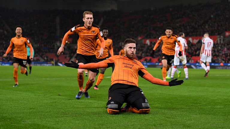 Matt Doherty slides in celebration after getting Wolves' second goal against Stoke