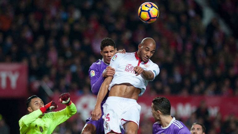 Real Madrid's French defender Raphael Varane (Top L) vies with Sevilla's French midfielder Steven N'Zonzi