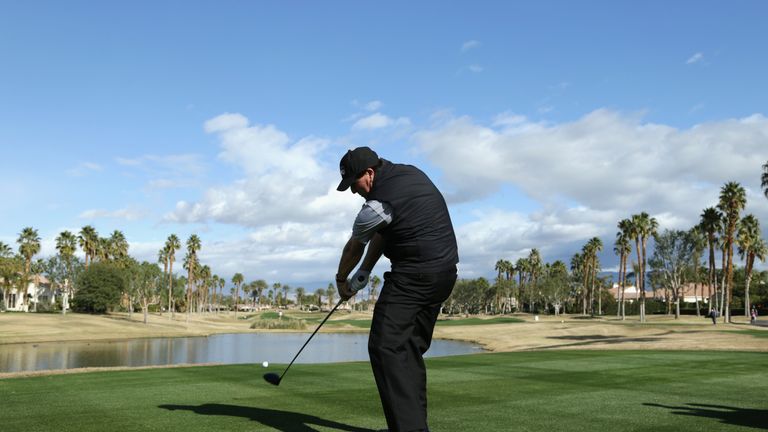 Phil Mickelson drives off the 13th tee