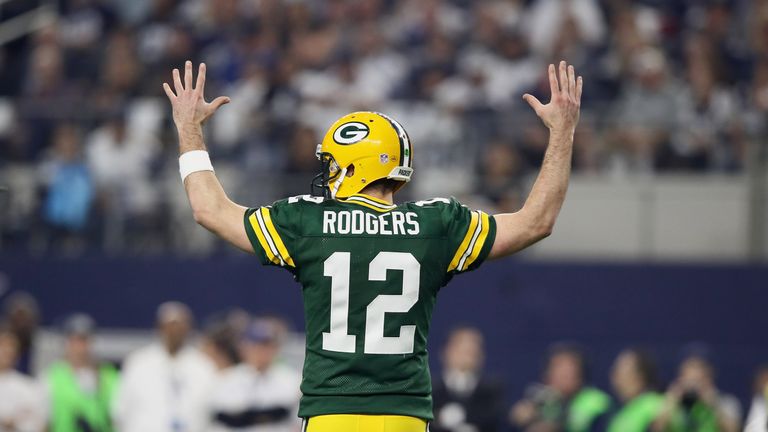 ARLINGTON, TX - JANUARY 15:  Aaron Rodgers #12 of the Green Bay Packers reacts after the Packers scored a touchdown against the Dallas Cowboys during the N