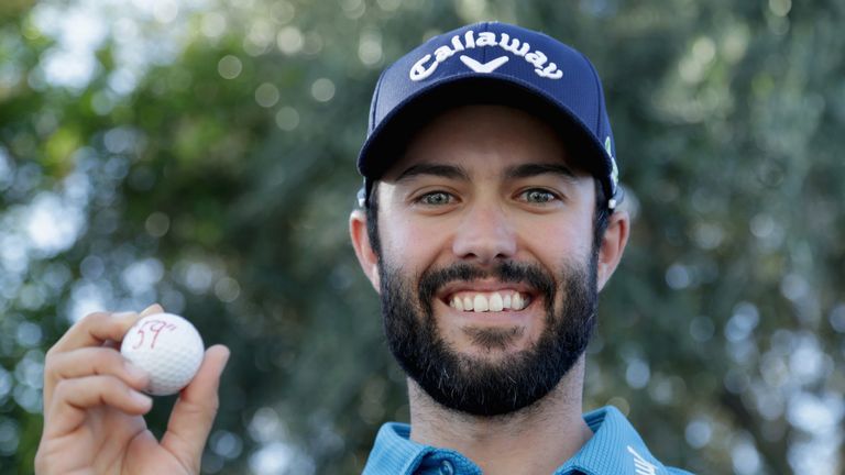 Adam Hadwin poses with his ball after shooting a 59 at La Quinta