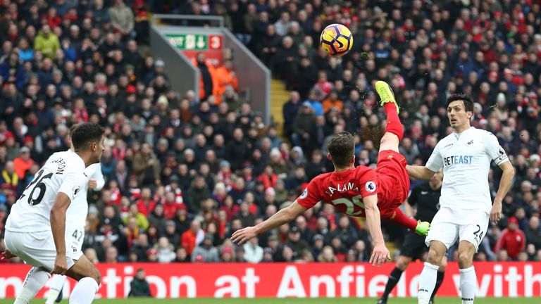 LIVERPOOL, ENGLAND - JANUARY 21: Adam Lallana of Liverpool (R) attempts a overhead kick during the Premier League match between Liverpool and Swansea City 