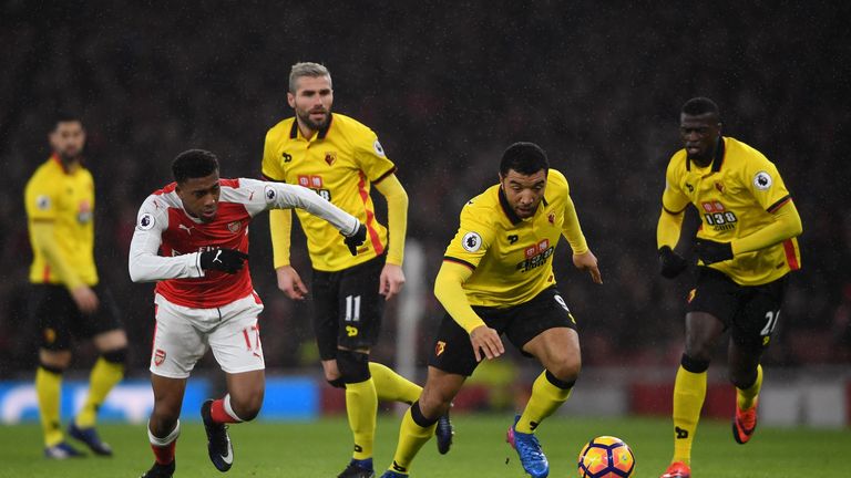 LONDON, ENGLAND - JANUARY 31: Troy Deeney of Watford and Alex Iwobi of Arsenal battle for the ball during the Premier League match between Arsenal and Watf