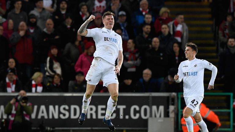 SWANSEA, WALES - JANUARY 31: Alfie Mawson (L) of Swansea City celebrates scoring the opening goal  during the Premier League match between Swansea City and