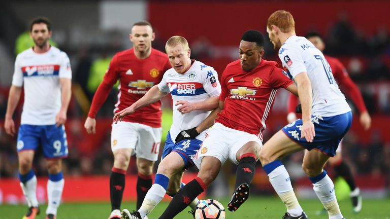 MANCHESTER, ENGLAND - JANUARY 29:  Anthony Martial of Manchester United battles with David Perkins and Shaun MacDonald of Wigan Athletic Anthony Martial of