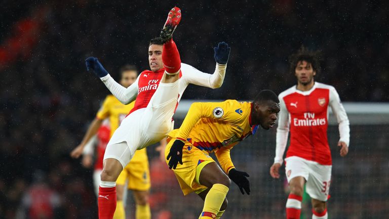 Gabriel and Christian Benteke battle for the ball