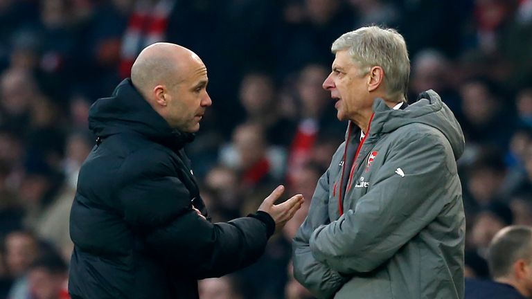 Fourth official Anthony Taylor (L) points Arsenal's French manager Arsene Wenger (R) to the tunnel after he was sent off by English referee Jonathan Moss (