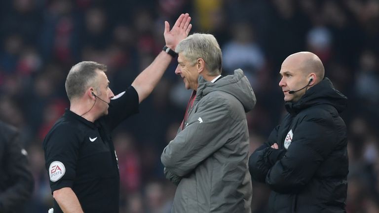 Referee Jonathan Moss orders Arsene Wenger to the stands during the match against Burnley