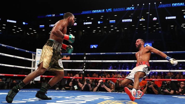 NEW YORK, NY - JANUARY 14:  Badou Jack knocks down James DeGale in the twelfth round during their WBC/IBF Super Middleweight Unification bout at the Barcla