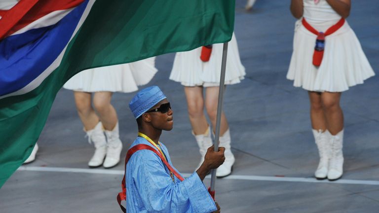Athlete Badou Jack (C) Gambia's flag bearer parades in front of his delegation during the 2008 Beijing Olympic Games opening ceremony