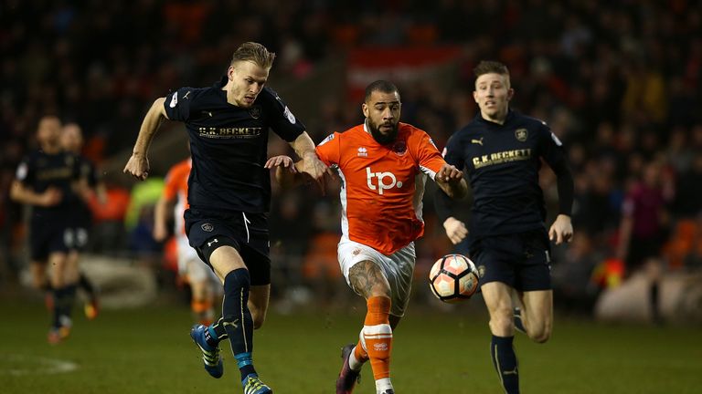 Kyle Vassell of Blackpool controls the ball under pressure from Barnsley duo Marc Roberts and Angus MacDonald 