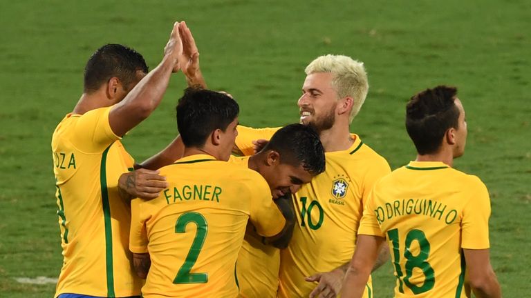 Brazilian Dudu (C) celebrates with teammates after scoring against Colombia during a friendly football match in benefit of Chapecoense football team at the