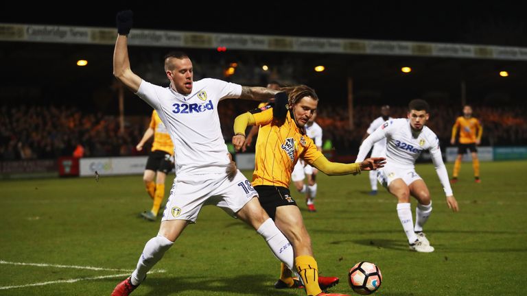 Luke Berry of Cambridge United battles with Leeds defender Pontus Jansson 