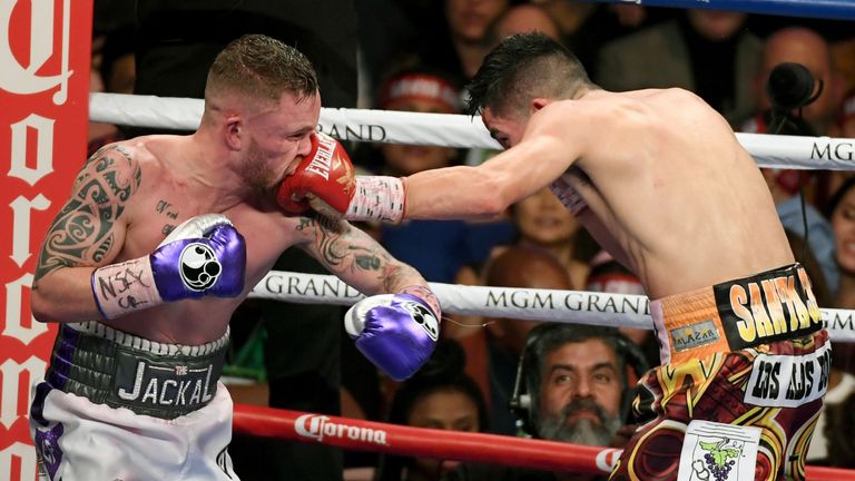 LAS VEGAS, NV - JANUARY 28:  Leo Santa Cruz (R) hits Carl Frampton with a left in the 11th round of their WBA featherweight title fight at MGM Grand Garden
