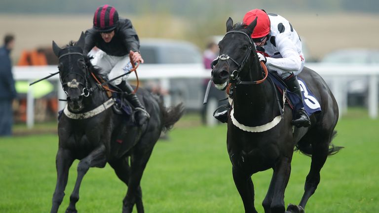 WETHERBY, ENGLAND - OCTOBER 31: Jockey Noel Fehily riding Charmix in a close battle with jockey Brian Hughes riding Ennistown during Novices' Hurdle Race (