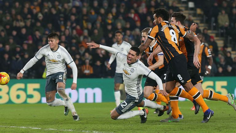 Chris Smalling of Manchester United is brought down by Tom Huddlestone of Hull City but no penalty is given