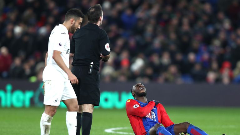 LONDON, ENGLAND - JANUARY 03:  Christian Benteke (R) of Crystal Palace holds his shoulder after challenged by Lukasz Fabianski of Swansea City in the box d