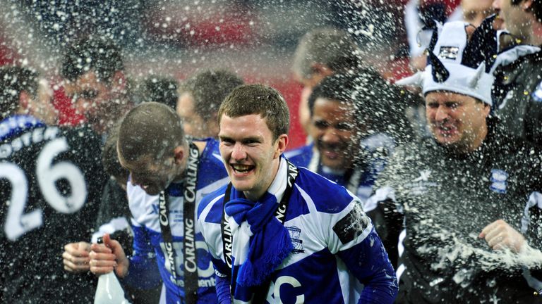 Birmingham City's English midfielder Craig Gardner (C) celebrates as teammates spray Champagne after the Carling Cup final football match between Arsenal a
