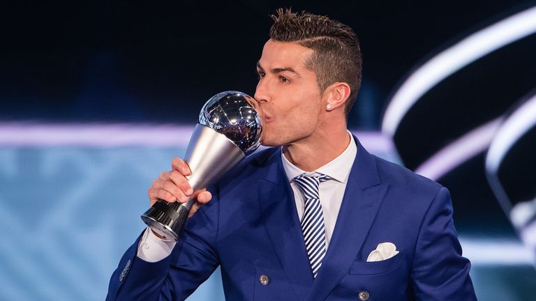 Cristiano Ronaldo kisses his trophy after winning the Best FIFA Men's Player Award