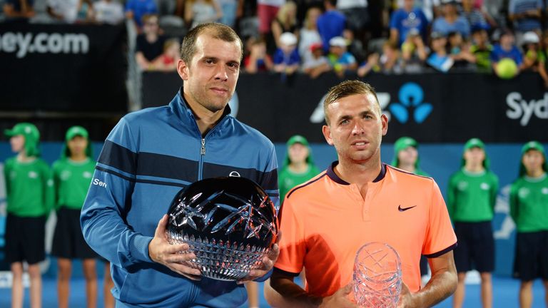 Gilles Muller of Luxembourg (L) and Dan Evans of Britain hold their trophies after Muller beat Evans in Sydney