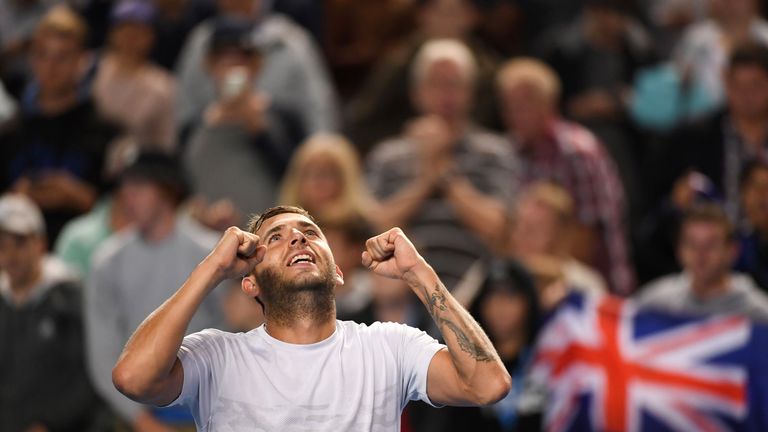 Dan Evans celebrates victory over Bernard Tomic on day five of the Australian Open