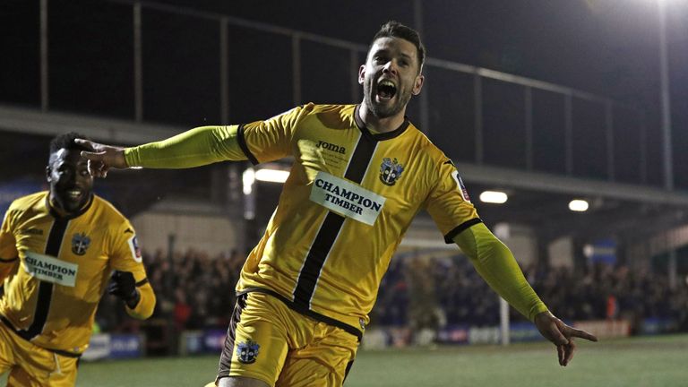 Sutton United's English striker Dan Fitchett celebrates scoring their third goal during the English FA Cup third round replay football match between AFC Wi