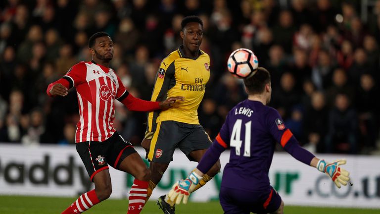 Arsenal's Danny Welbeck (C) chips the ball over Harry Lewis (R) to score his team's first goal