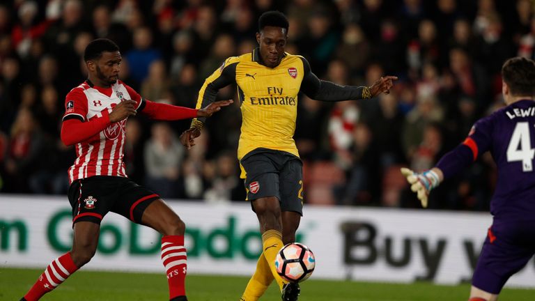 Arsenal striker Danny Welbeck (C) chips the ball over Southampton goalkeeper Harry Lewis