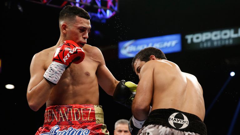 David Benavidez (L) punches Sherali Mamajonov during the second round of their super middleweight fight at MGM Grand