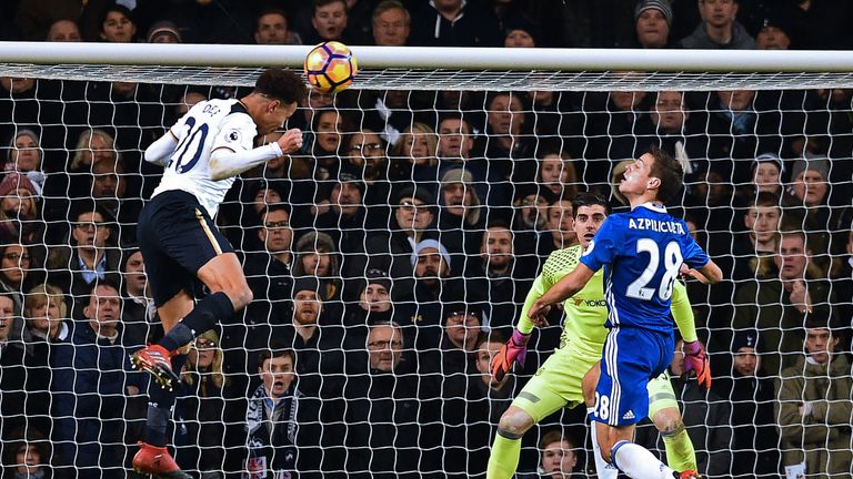 Dele Alli directs his looping header into the top corner of Thibaut Courtois' goal