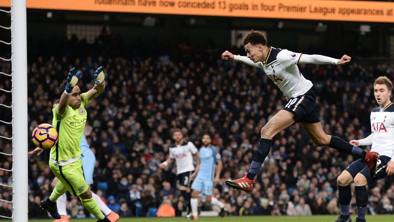 Tottenham Hotspur's English midfielder Dele Alli (2nd R) jumps to head their first goal past Manchester City's Chilean goalkeeper Claudio Bravo (L) during 