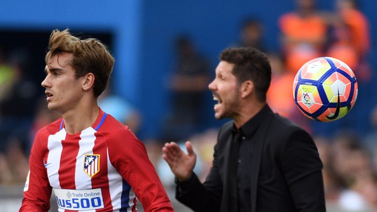 Atletico Madrid's French forward Antoine Griezmann (L) throws the ball beside Atletico Madrid's Argentinian coach Diego Simeone 