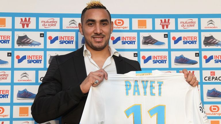 Dimitri Payet poses with his shirt during a press conference at Olympique de Marseille's training ground