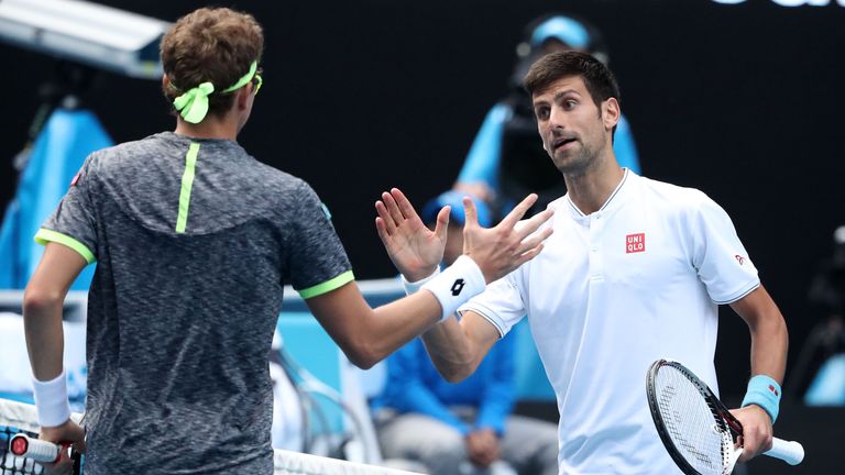 Novak Djokovic congratulates Denis Istomin after the Uzbek knocked him out of the Australian Open