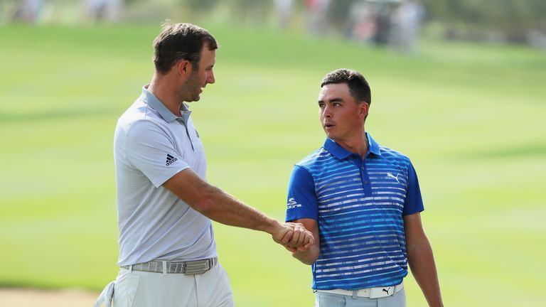 ABU DHABI, UNITED ARAB EMIRATES - JANUARY 21:  Dustin Johnson (L) of the United States shakes hands with Rickie Fowler on the 18th green during the third r