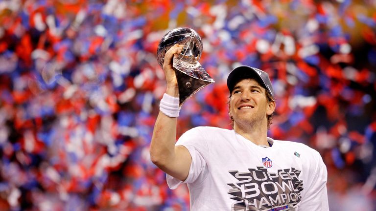 INDIANAPOLIS, IN - FEBRUARY 05:  Quarterback Eli Manning #10 of the New York Giants poses with the Vince Lombardi Trophy after the Giants defeated the Patr