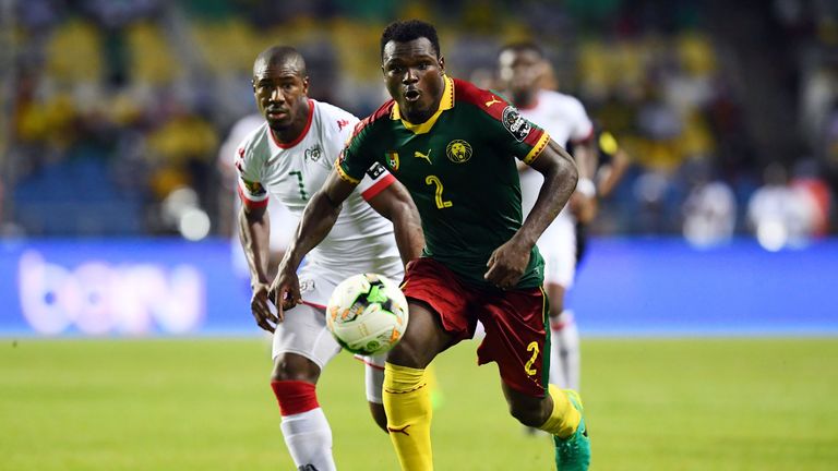 Cameroon's defender Ernest Mabouka (front) advances with the ball past Burkina Faso's midfielder Prejuce Nakoulma during the 2017 Africa Cup of Nations gro