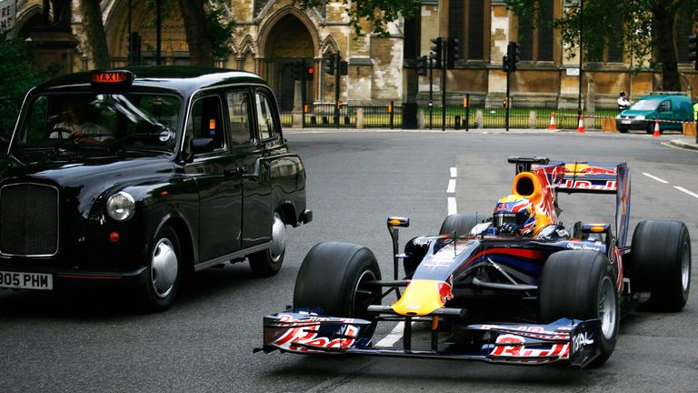 Mark Webber drives round Parliament Square and completes a pit stop in front of the Houses of Parliament in 2010
