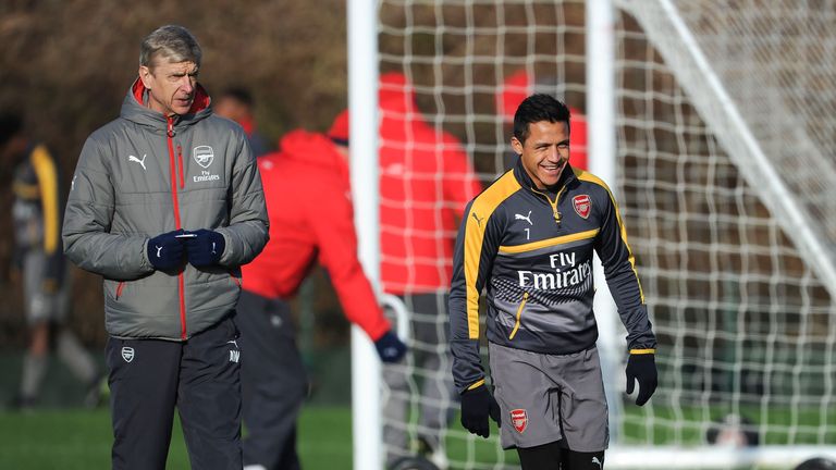 Arsene Wenger with Alexis Sanchez during a training session at London Colney