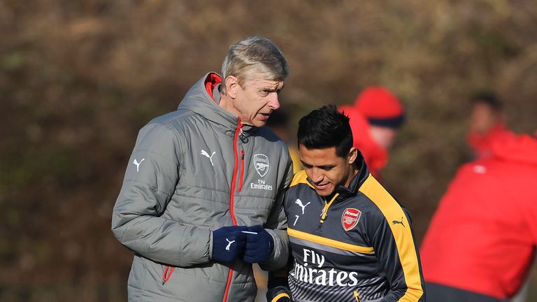 Arsene Wenger chats with Alexis Sanchez during a training session at London Colney