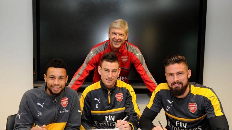 Arsenal's Francis Coquelin, Laurent Koscielny and Olivier Giroud sign their new contracts with manager Arsene Wenger at London Colney
