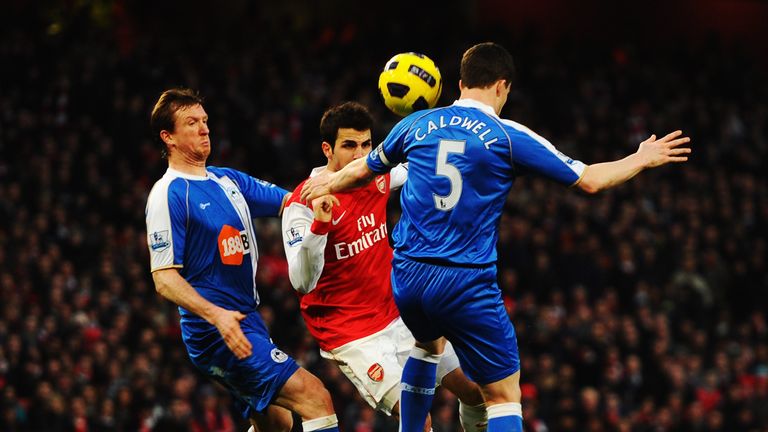 LONDON, UNITED KINGDOM - JANUARY 22:  Steven Caldwell (L) and his brother Gary Caldwell (R) of Wigan Athletic challenge Cesc Fabregas (C) of Arsenal during