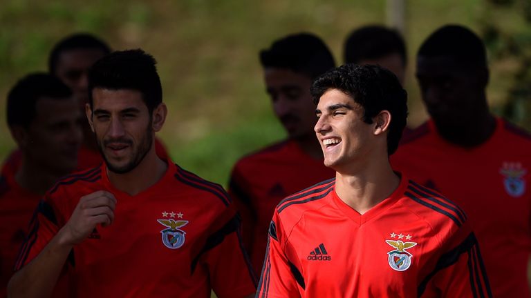 Benfica's forward Goncalo Guedes (R) smiles as he and teammates arrive for a training session at the Benfica's training ground in Seixal, outskirts of Lisb
