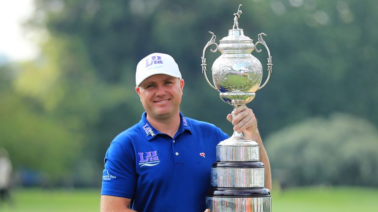 Graeme Storm of England celebrates with the trophy after winning the BMW South African Open Championship at Glendower