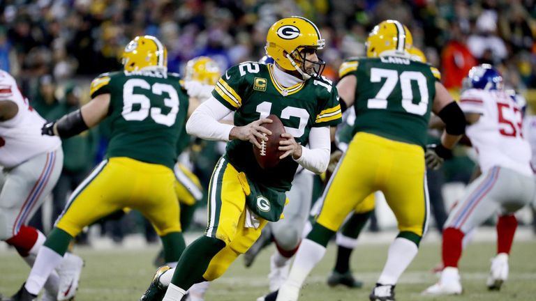 GREEN BAY, WI - JANUARY 8:  Aaron Rodgers #12 of the Green Bay Packers drops back to pass in the second quarter during the NFC Wild Card game against the N